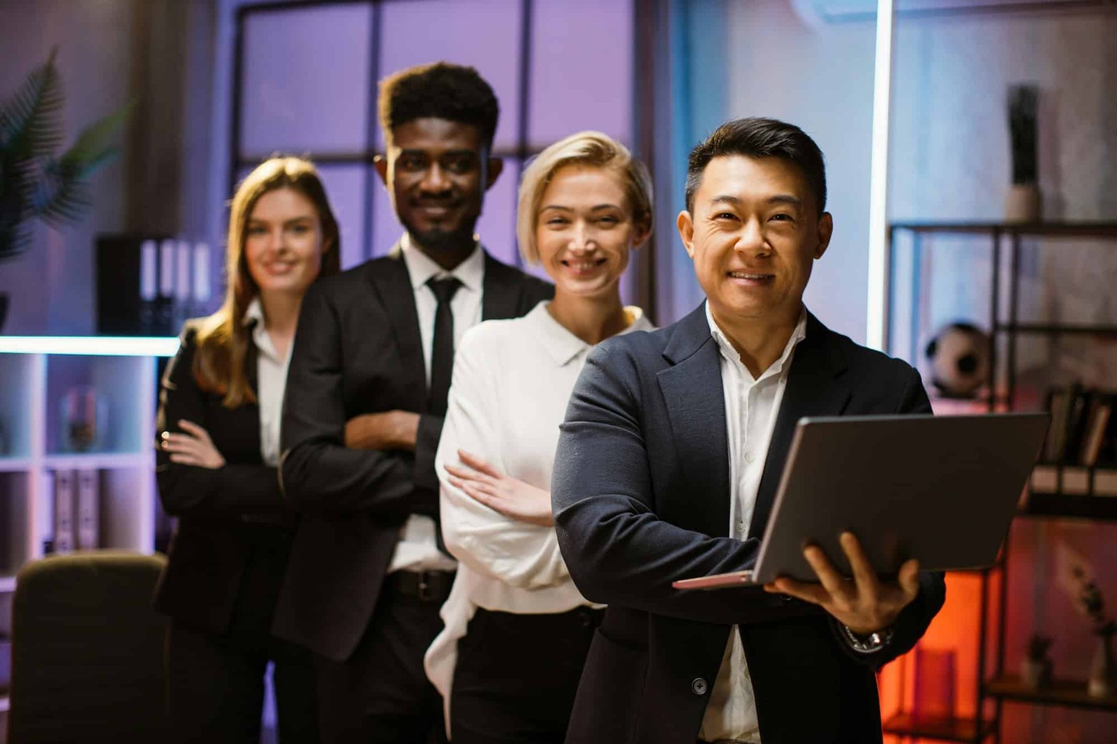 multiethnic-happy-company-workers-standing-in-a-row-in-creative-office-posing-on-camera