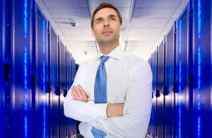 man standing in server room contemplating the best website hosting for small business